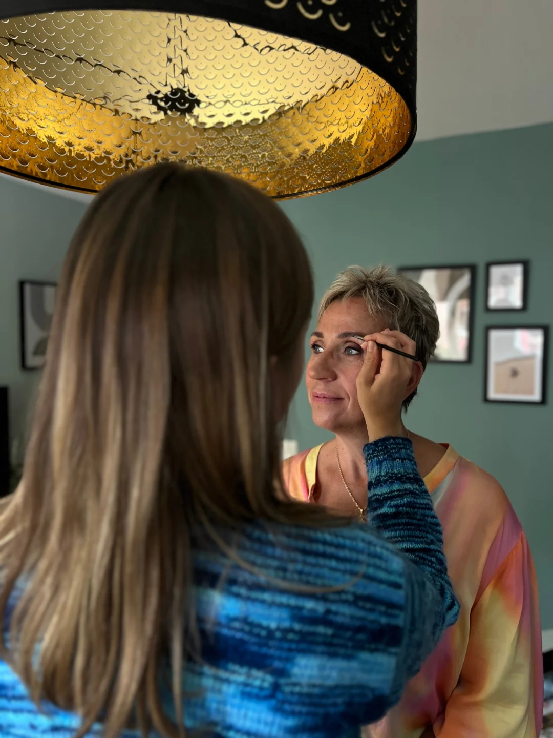 Lovina shaping a client's brows at home