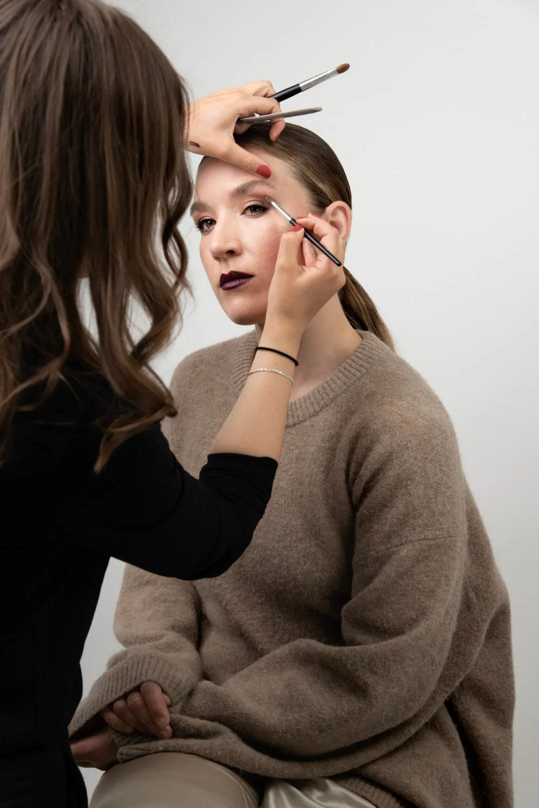 Lovina applying eyeshadow in the studio