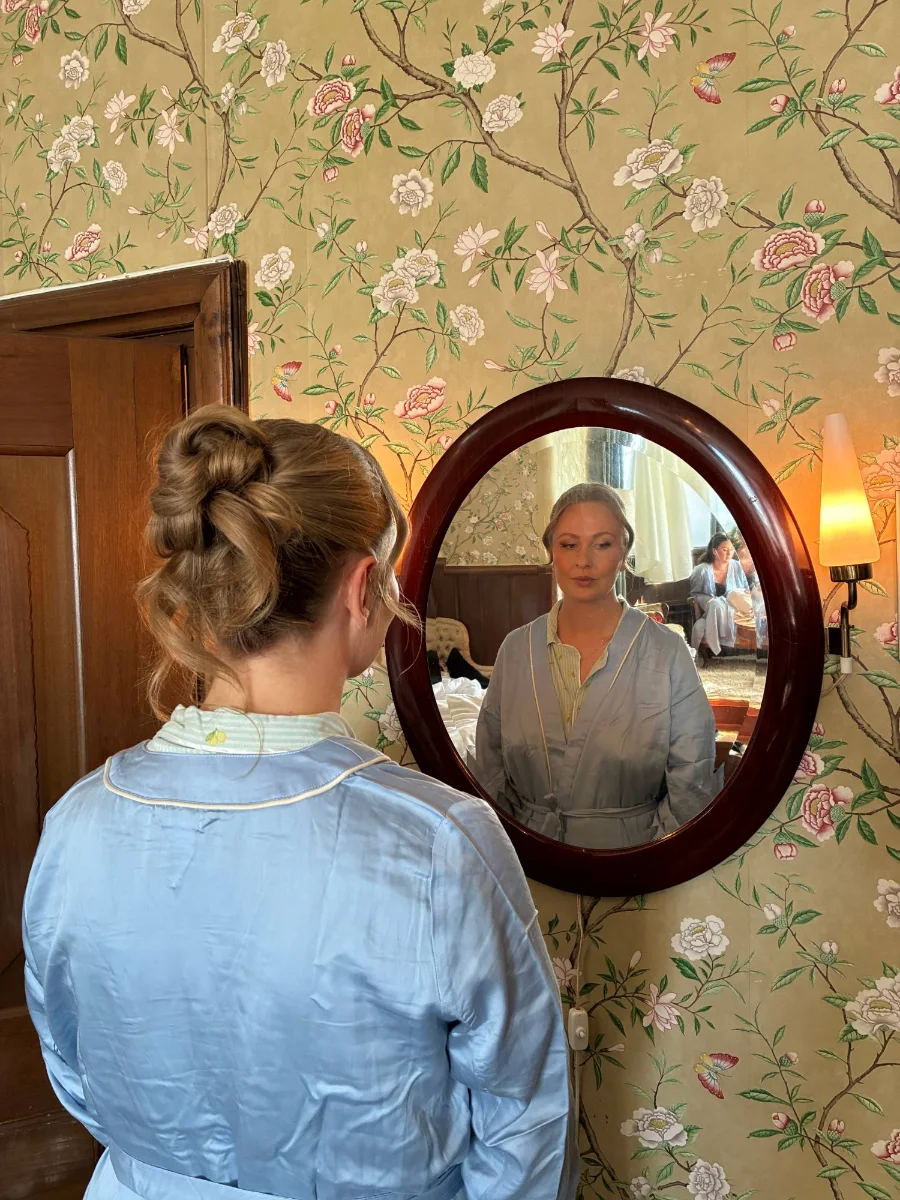Bridal updo and makeup reflected in a mirror, by Lovina Riahi