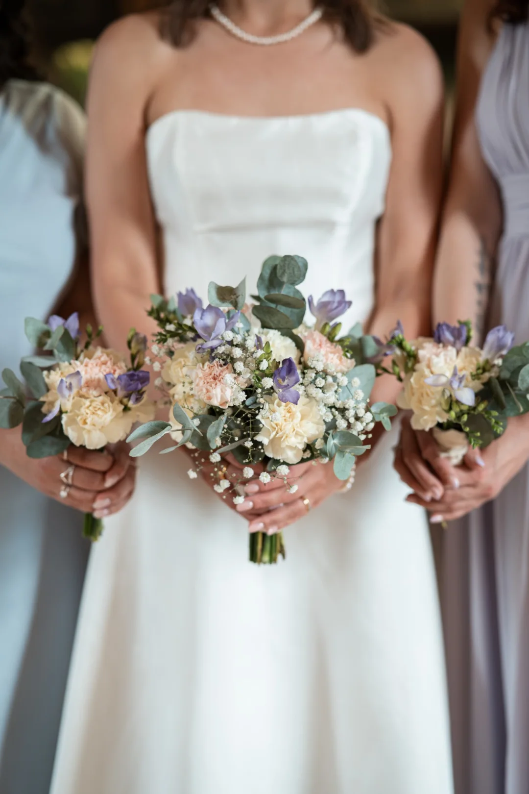 A bride and her bridesmaids holding their bouquets
